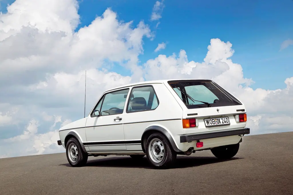White Volkswagen Golf GTI classic car parked under a cloudy sky